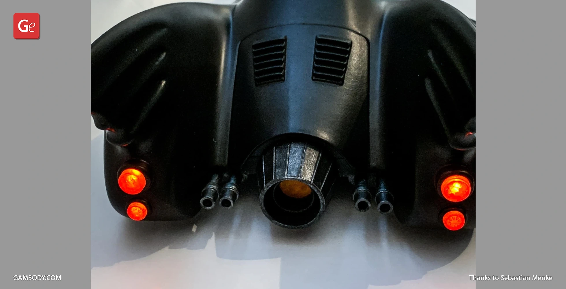 Close-up of the rear of a 1989 Batmobile model with glowing red lights and detailed exhaust.