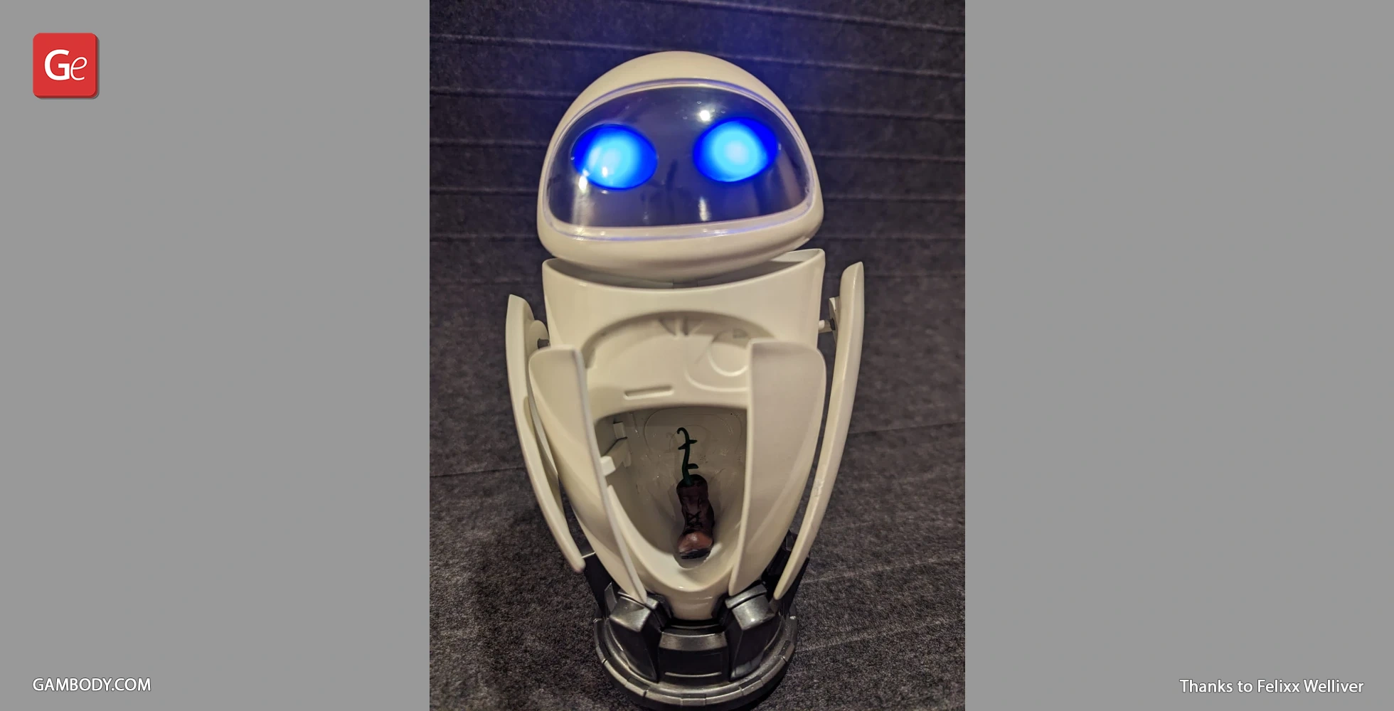 A model of a robot with glowing blue eyes and an open compartment holding a small plant in a boot.