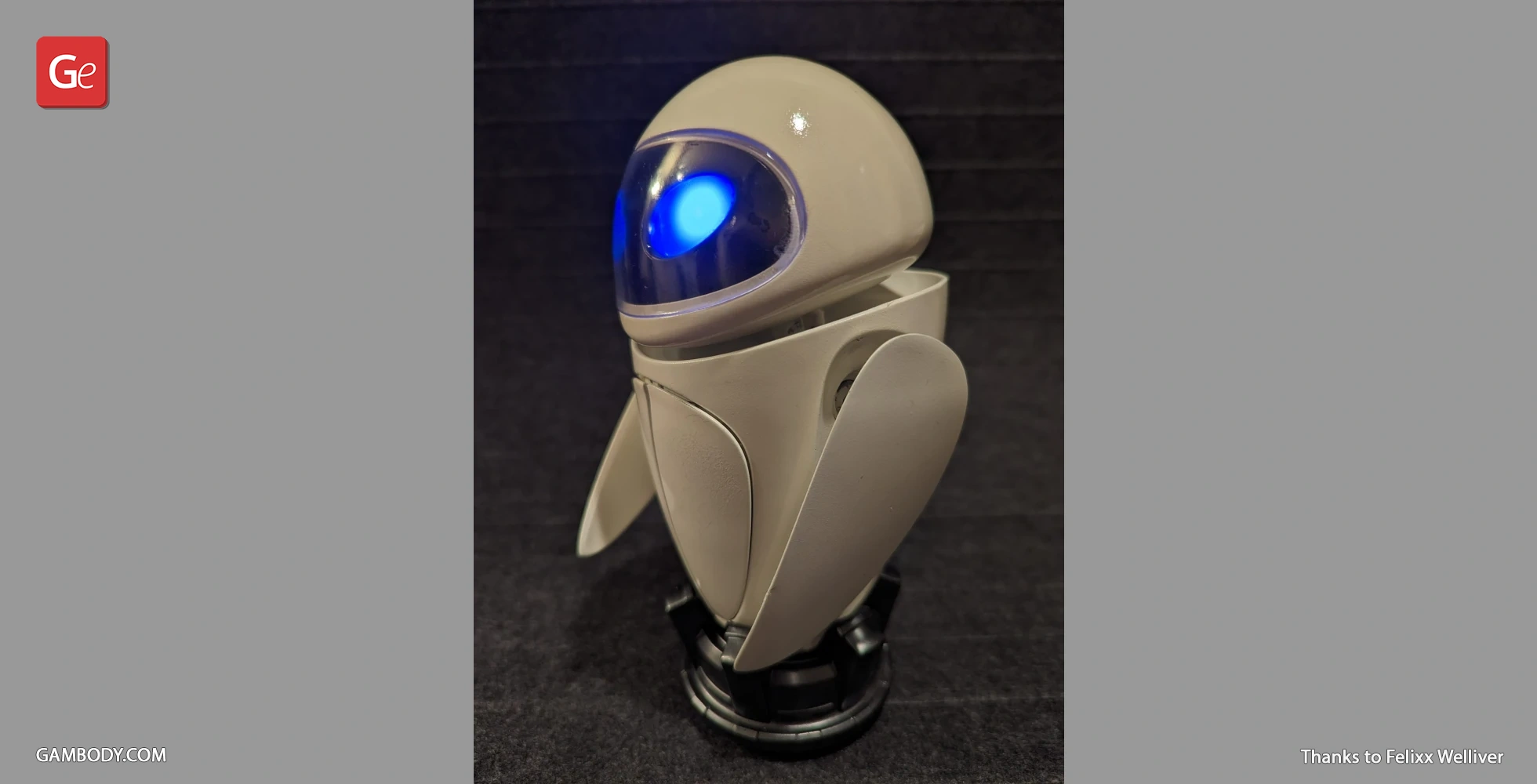 Futuristic robot figure with glowing blue eye and sleek white body on a dark base.