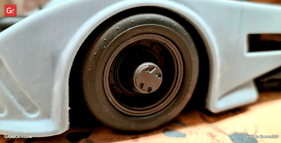 Close-up of a 3D-printed Batmobile 1989 wheel with detailed rim design.