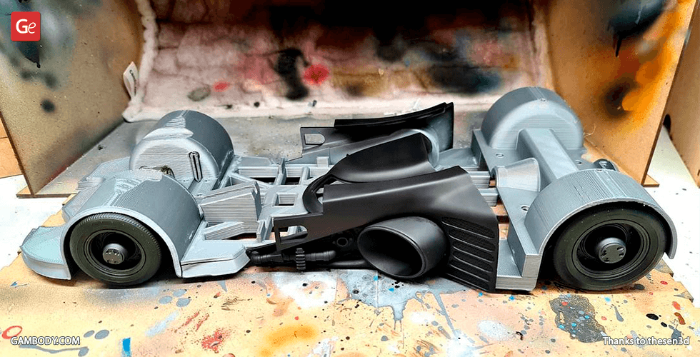 3D printed model of the Batmobile 1989, partially assembled and unpainted, on a spray booth surface.