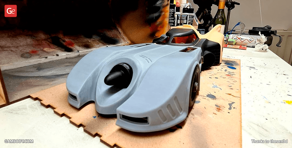 A detailed 3D model of the Batmobile 1989 for printing, shown on a workbench.