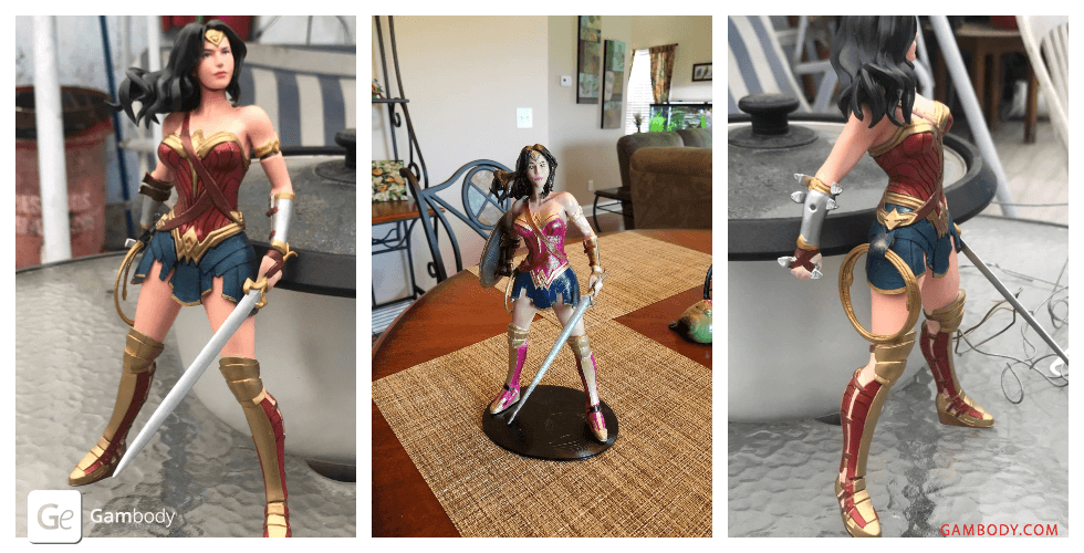 A 3D-printed Wonder Woman figure in a dynamic pose with sword and shield.